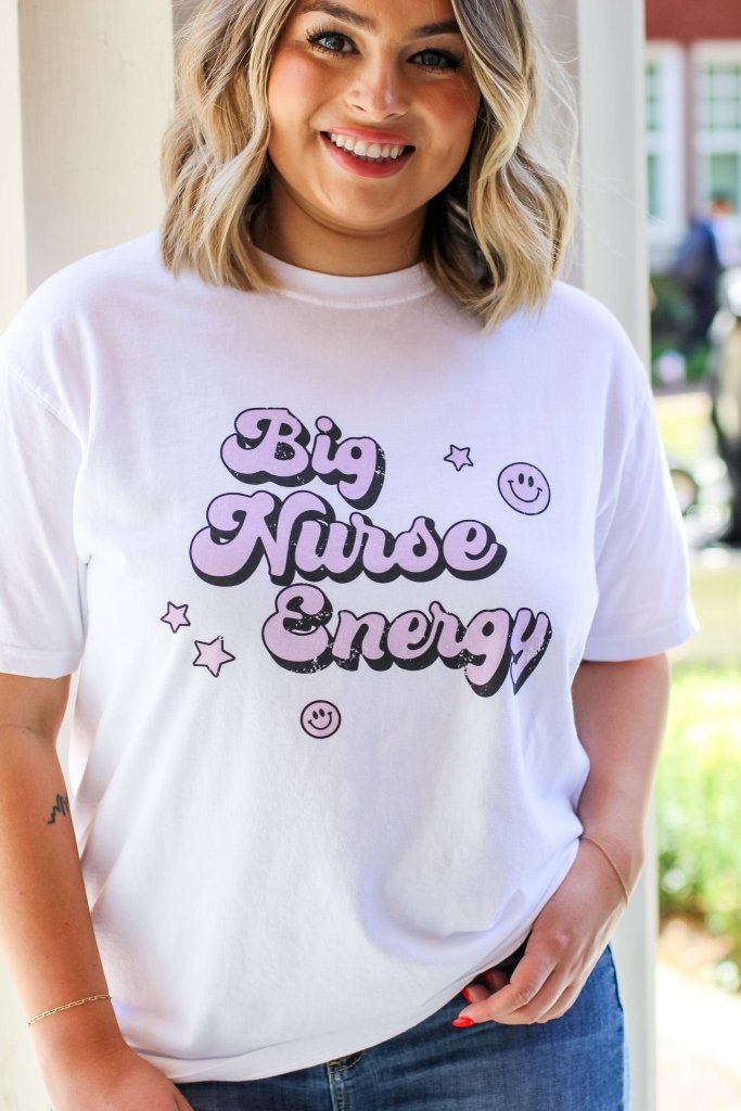 White tee with "Big Nurse Energy" in bubble letters in pink 