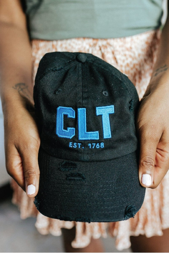 CLT Distressed Hat in Black with Keep Pounding Blue Stitch - Girl Tribe Co.