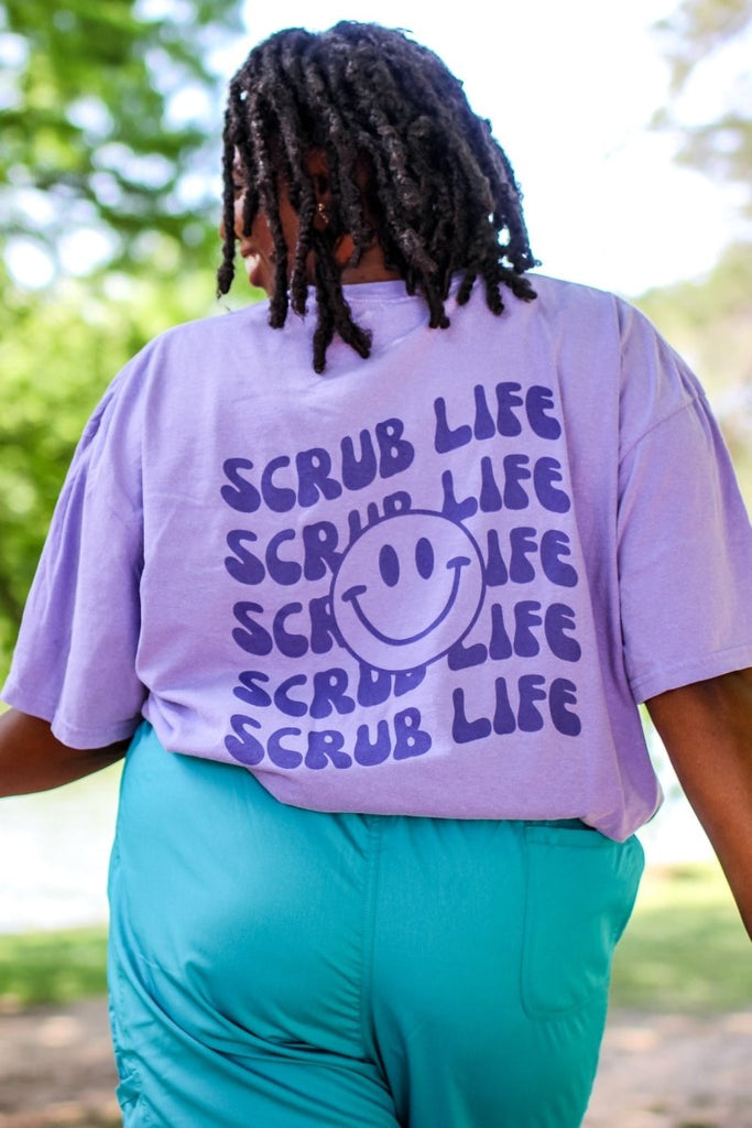 Light purple tee shirt with "Scrub Life" repeated on the back in a dark purple color