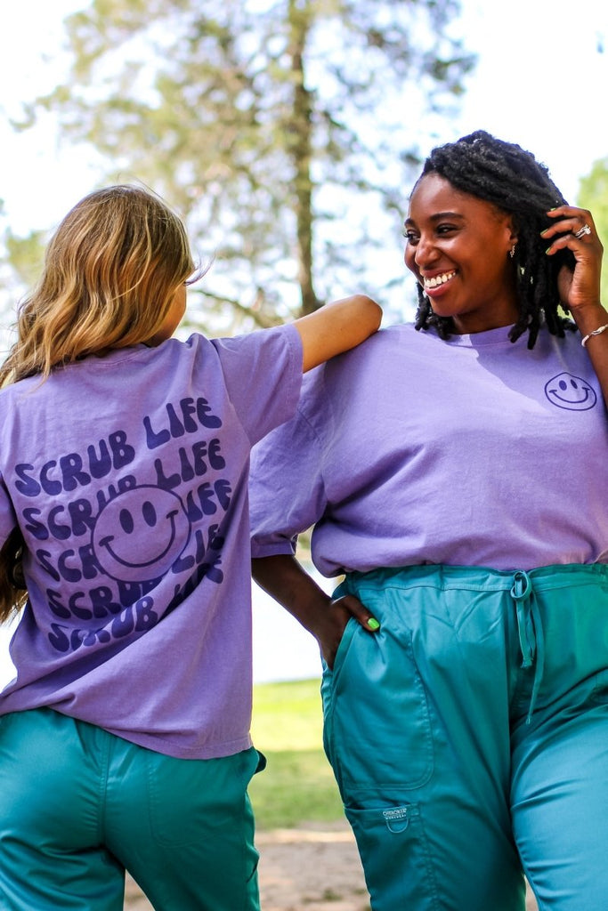 Light purple tee shirt with "Scrub Life" repeated on the back in a dark purple color